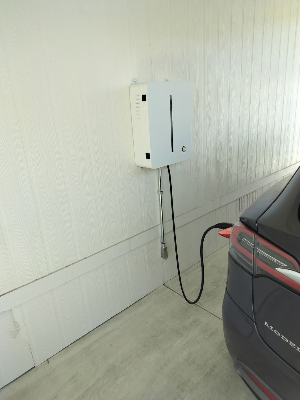 Tesla Model Y plugged into a newly installed home EV charger