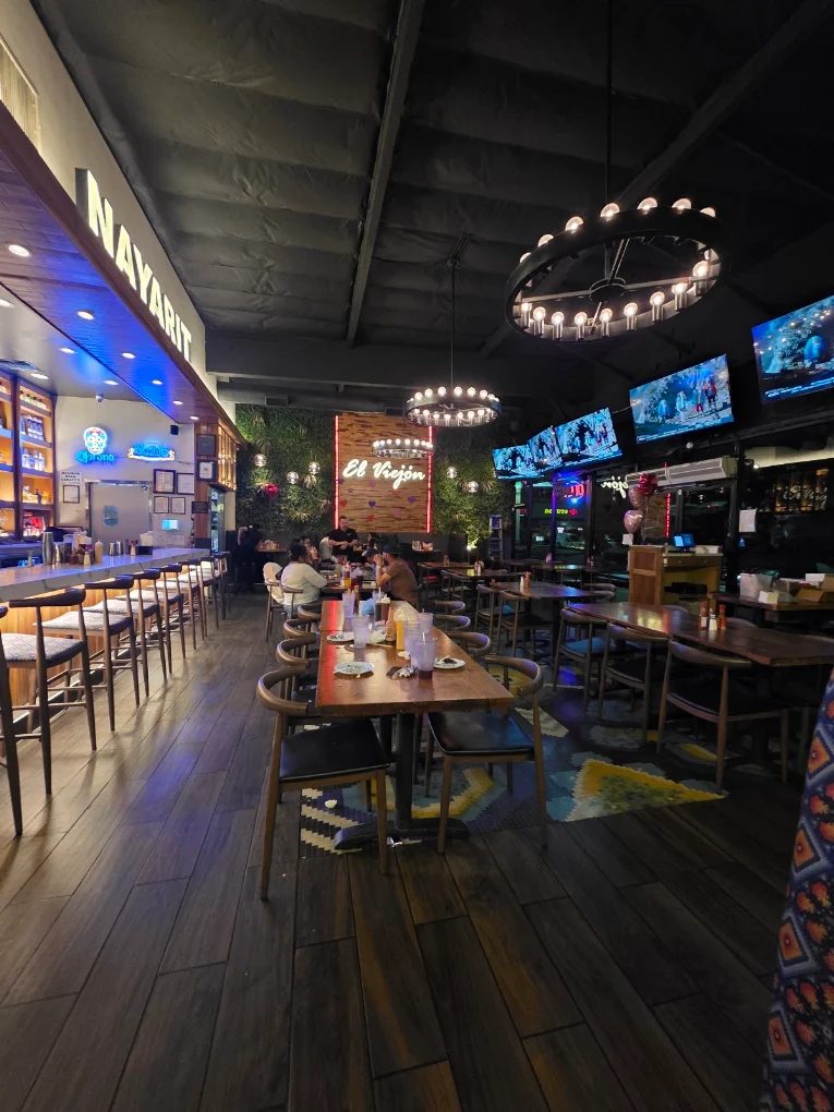 Wall-mounted TVs with concealed cable management installed in a restaurant bar